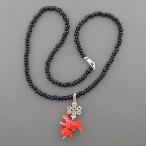 Enjoy this handmade dragon bead necklace with red or black Czech glass beads. Matching earrings available.