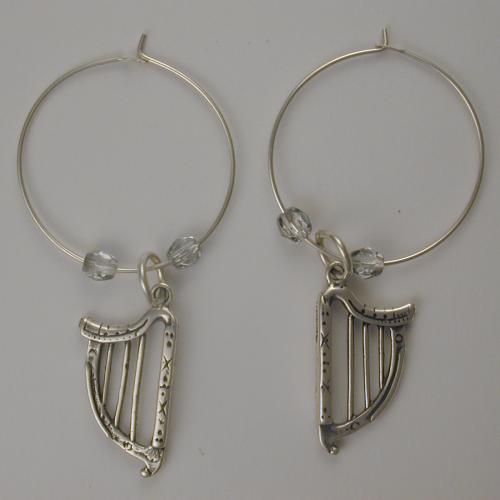 Sterling silver hoop with a sterling silver Celtic harp flanked by two clear Czech glass beads.