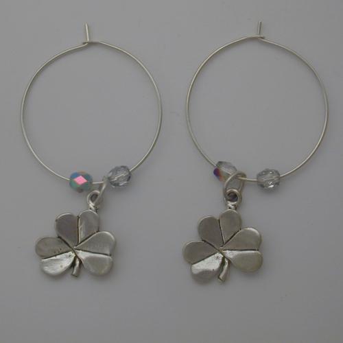 Sterling silver hoop with a sterling silver shamrock flanked by two clear Czech glass beads.
