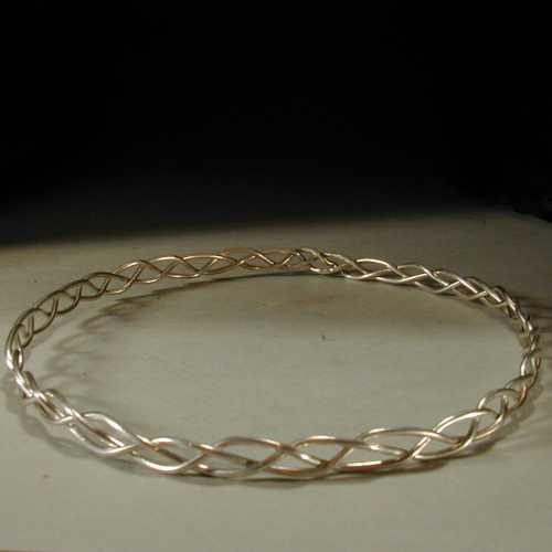 This is a simple appearing circlet made with three strands of sterling silver wire.  The circlet is 3/8-inch high.