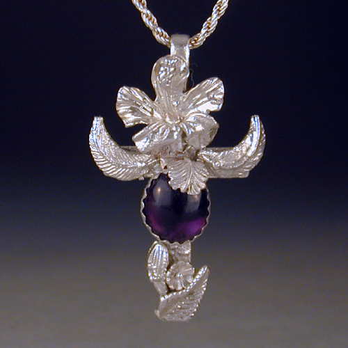 This cross covered with leaves and flowers also has a lovely amethyst cabochon.