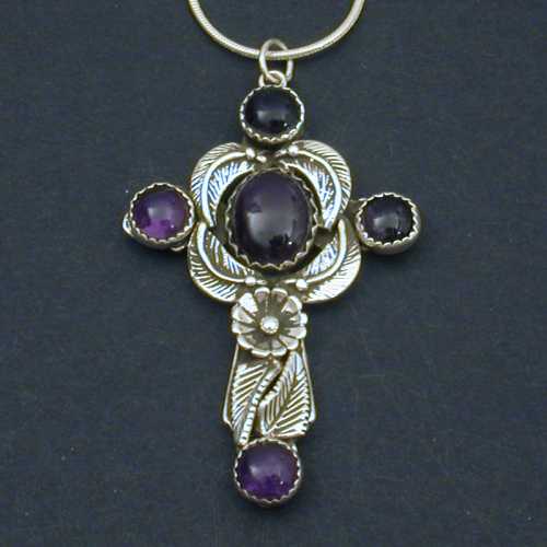One of our finest crosses yet. Decorated with leaves, and amethyst cabochons in a floral motif this cross is sure to please.