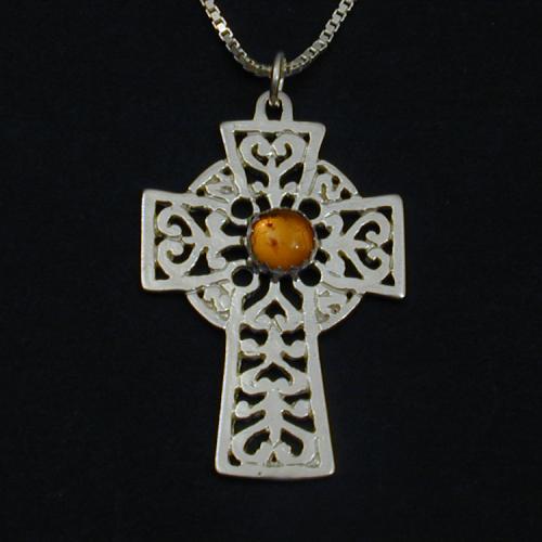 This lovely celtic cross holds an amber cabochon.