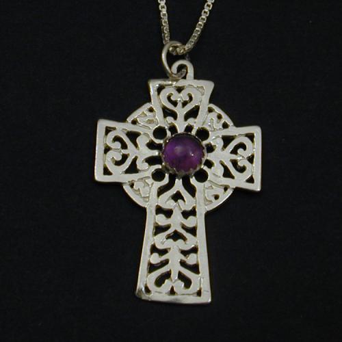 This lovely celtic cross holds an amethyst cabochon. 