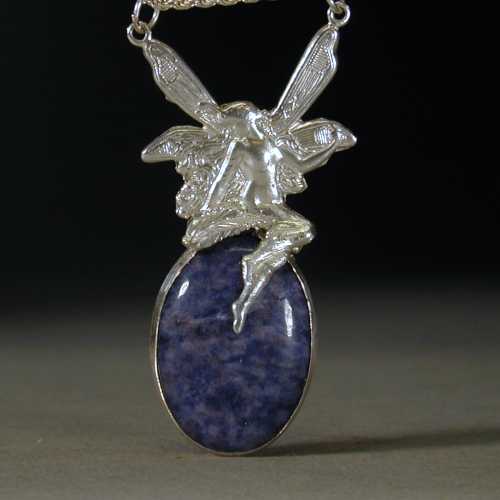 Sterling silver fairy gazing into a blue stone pool.