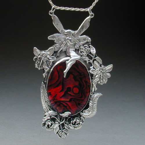 Fairies play in and around the roses in this pendent of sterling silver and red paua shell. Stop and smell the roses with this fine piece of jewelry.