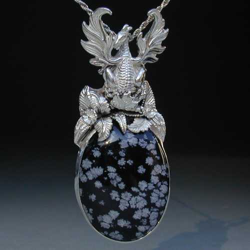 Imagine a moonlit night with the cold snow falling down in this dragon pendent of sterling silver and snowflake obsidian. Feel the chill of delight you will experience wearing this fine necklace.