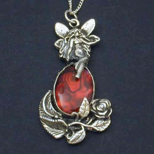 A smaller version of the rose fairies .  This piece is sure to please any fairy or rose lover. The fairy sits atop a red paua shell.