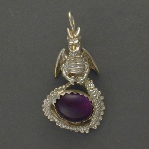 This dragon holds an oval Amethyst protectively in its coiled tail.