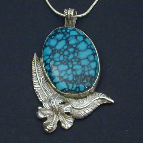 This lovely floral pendent set with turquoise is sure to please the most discriminating.