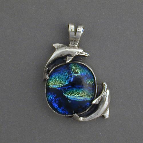 Watch the dancing dolphins swimming in the swirling blue and green waves of this beautiful dicroic glass. Feel the dance.