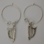 Sterling silver hoop with a sterling silver Celtic harp flanked by two clear Czech glass beads.