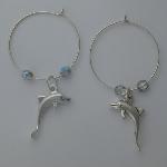 Sterling silver hoop with a sterling silver dolphin flanked by two clear Czech glass beads.