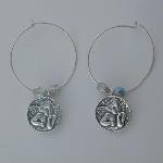 Sterling silver hoop with a sterling silver cherub flanked by two clear Czech glass beads.
