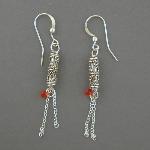 These sterling silver earrings are made with loving care. A red drop bead serves to accent these lovely earrings. Available in french wire or hoop style.