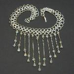 This elegant necklace is made from sterling silver rings in a four in one pattern.  Suspended from delicate sterling silver chains are beautiful Austrian Crystals.