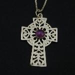 This lovely celtic cross holds an amethyst cabochon. 