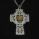 This lovely celtic cross holds an peach moonstone cabochon. 