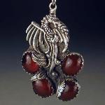 Flaming dragon rises out of the embers of 4 carnelian cabochon stones.
