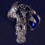 Have powerful dragon wraped around your finger with this large sterling silver ring.  The stone in the one of a kind piece is AA grade lapis.