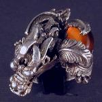 Have powerful dragon wraped around your finger with this large sterling silver ring.  The stone in the one of a kind piece is Amber.