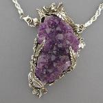 One of our most opulent pendants. This naturally colored cluster of amethyst geode crystals is a rich, dark purple. This pendant is meant for living large.