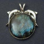 The image of dolphins playing in the moonlight comes to mind in this beautiful dolphin and labradorite moon pendent.
